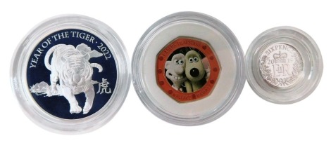 A group of Royal Mint collectors coins, comprising a Lunar Year of the Tiger 2022 one ounce silver proof coin, boxed, a Wallace and Gromit Treasure of Life 2019 UK fifty pence silver proof coin, and a Royal Mint Treasured Christmas 2019 silver sixpence, b