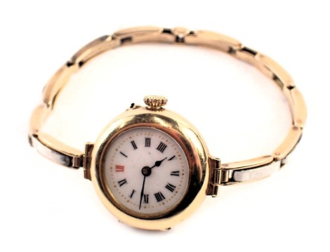 An 18ct gold cased wristwatch, the circular watch head with white enamel Roman numeric dial, blue hands and gold outer pointers, with inner cover numbered 145248, with seventeen jewel movement, on expanding bi-colour bracelet, unmarked, with additional li