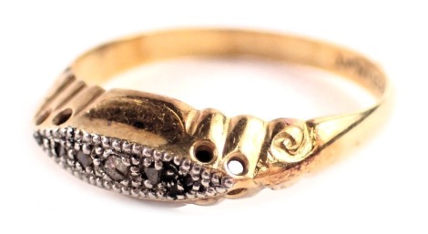 An Edwardian diamond gypsy ring, set with five tiny diamonds in a platinum claw setting, on a yellow metal scroll band stamped 18ct plat, ring size R½, 2.8g all in.