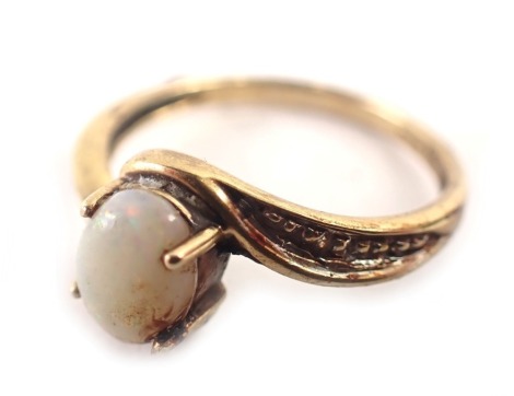 A 9ct gold dress ring, the oval opal in four claw setting, with twist design shoulders, bead effect, ring size M, 1.8g all in.