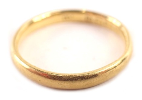 A 22ct gold wedding band, of thin plain design, London 1908, ring size M, 2.9g.