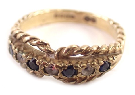 A 9ct gold dress ring, set with sapphire and CZ stones, with a rope twist outer halo, maker JH, Birmingham 1978, ring size I, 2.4g all in.