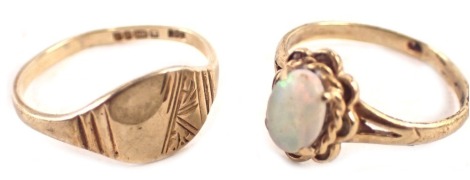 Two 9ct gold dress rings, comprising an opal single stone dress ring with petalated border, ring size J½, a 9ct gold signet ring, with patterned head, ring size L, 2.8g all in.