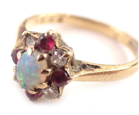 A 9ct gold cluster ring, set with central oval opal in eight claw setting, surrounded by garnets and CZs, on a yellow metal band, rubbed hallmarks, ring size I½, 1.8g all in.