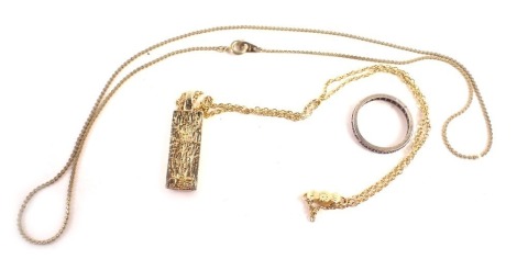 A small group of jewellery, comprising a white metal and CZ set eternity ring stamped 835, one stone missing, a gold plated imitation ingot pendant and chain, and a plated neck chain. (3)