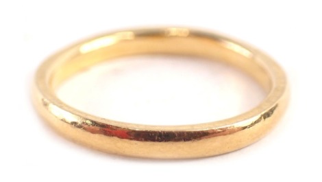 A wedding band, of thin and plain design, yellow metal stamped 22, ring size O, 4g all in.