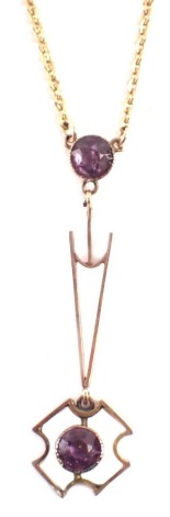 An Art Nouveau style pendant and chain, the pendant of drop form, set with two amethysts, 4cm high, in yellow metal backing, unmarked, on a later watch chain with clip clasp, unmarked, 46cm long, 4.8g all in, boxed.