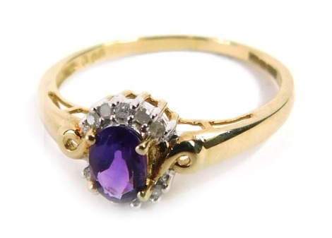 A 9ct gold dress ring, set with oval cut amethyst and outer halo of ten CZ stones, on twist design shoulders, ring size T½, 2.1g all in.