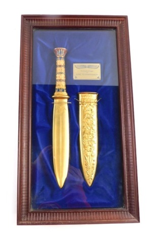 A Franklin Mint presentation replica gold dagger of King Tutankhamun, enamel decorated with gold coloured finish, in presentation case with care and handling guide, the case 47cm x 25.5cm x 7.5cm.