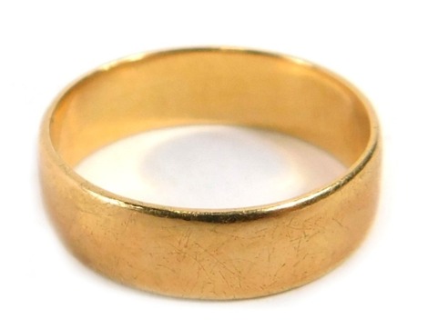 A wedding band, of plain design, yellow metal stamped 750, ring size I½, 2.9g all in.