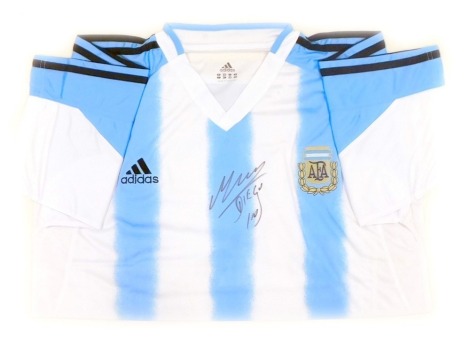 An Adidas signed Argentina football home shirt, with certificate of authenticity, marked Diego Maradona, in modern frame, 49cm x 69cm.