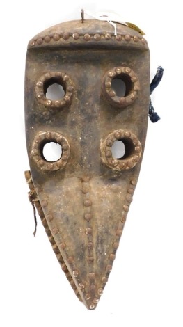 A Grebo (Krou) Maou four eyed warrior mask with articulated Jaw, Liberia, 45cm high.