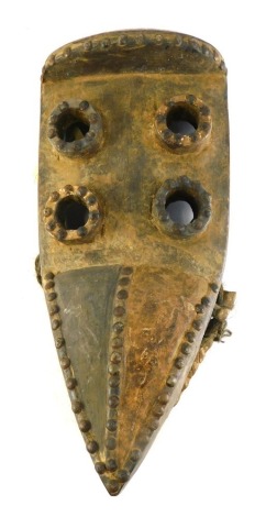 A Grebo (Krou) Maou four eyed warrior mask with articulated Jaw and metal studs, Liberia, 42cm high.