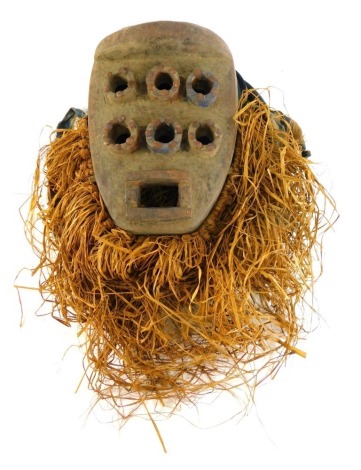 A Grebo (Krou) Maou six eyed warrior mask with metal studs, Liberia, 33cm high.