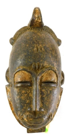 A Baule Mblo spiritual portrait mask, Cote D'Ivoire, 33cm high.