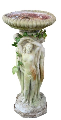 A reconstituted stone bird bath, the top with a moulded border on a stem set with three semi clad females, and Greek gods, with flowers, on octagonal base, 80cm high, 35cm diameter.