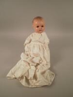 An Armand Marseille no. 518 composition doll with clothing