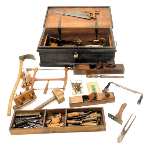 A 19thC black painted pine ships carpenter's tool chest and contents, to include wood block planes, a miniature plane, chisels, screwdrivers, saws, etc., 33cm high, 87cm wide, 40cm deep.