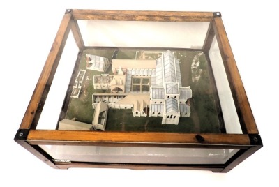 A model of diorama of Roche Abbey, showing the building, courtyard and surrounding landscape, in stained pine and perspex case, 67cm wide.