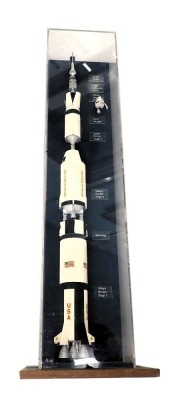 A scale model of Apollo, Saturn, America's Moon Rocket, scale of 1cm:1.44m, polychrome decorated, realistically painted and with lunar module, etc., in perspex case and wooden base, 99cm high overall.