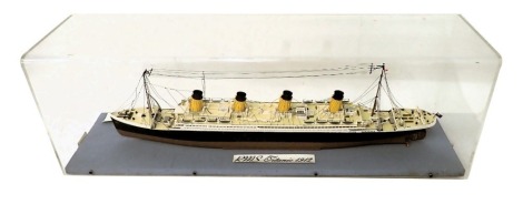 A scale model of the R.M.S Titanic, circa 1912, with four masts, polychrome decorated, in perspex case, 91cm wide.