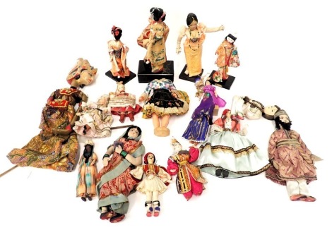 A quantity of mainly Eastern costume dolls, to include Japanese dolls, musical doll with ceramic head and hands, etc., a Thai puppet, plastic nodding dolls, etc.