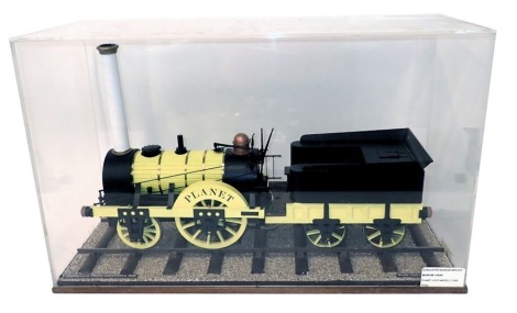 A scale model of Stephenson's Planet locomotive circa 1830, in black and yellow livery, 1cm:12cm scale, seated on stylised track, in perspex and wooden case, 70cm wide.