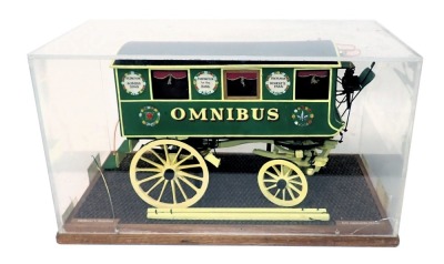 A scale model of a horse drawn omnibus coach, in black, green and yellow livery, 1cm:12cm, in perspex and wooden case, 54cm wide.