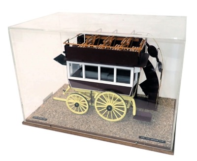 A model of an early 20thC horse omnibus or carriage, in orange, maroon, white and yellow livery, within a wood and perspex case, 51cm wide.