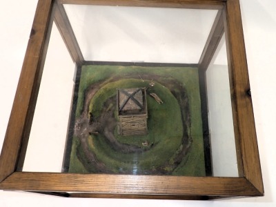 A diorama model of a Roman watch tower, with surrounding ditches, etc., in wood and perspex case, 47cm wide. - 2