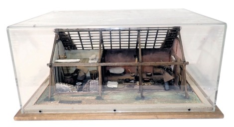 A diorama model of a Viking dwelling, showing various cooking vessels, living quarters, etc., in pine and perspex case, 60cm wide.