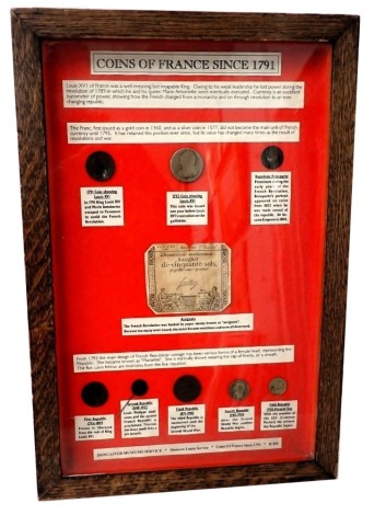 A display case showing the coins of France in 1791, (coins AF), in oak and perspex case, 47cm x 32cm.