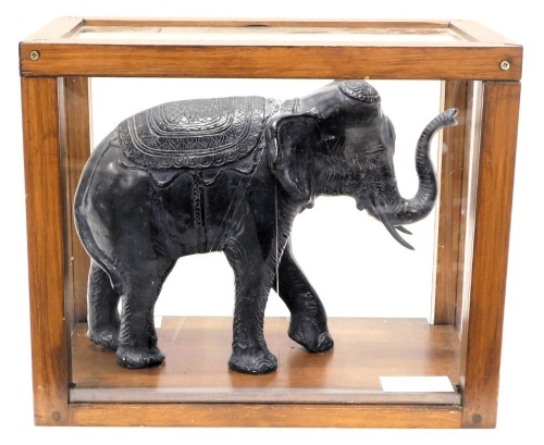 A replica composition model of an elephant in Indian style, within perspex and wooden case, the case 37cm high, 45cm wide, 25.5cm deep.