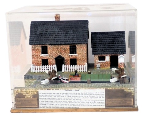 A diorama model of a lock keeper's cottage, lock and a barge or narrow boat, in perspex case, 34cm wide.