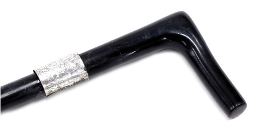 An early 20thC ebony walking cane, with silver collar, London 1927, 87cm long.