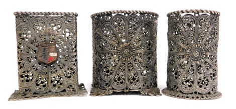 Three items of Middle Eastern silver plated filigree, comprising circular vase, 6cm high, stem vase, 5cm high, rectangular vase, 5cm high. (3)