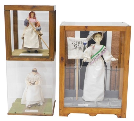 Three costume dolls of people through the ages, to include suffragette, monk, and a 19thC female farm worker.