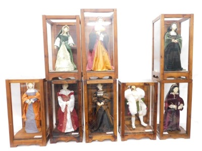 A group of models of Henry VIII and six of his wives, and a Tudor lady, in glazed Perspex case, 64cm high, 32cm wide.