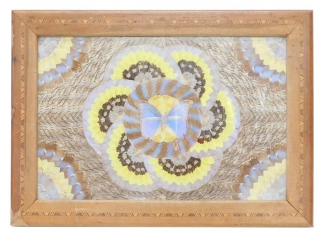 A hardwood table top, inset with a geometric design of butterflies, lacking feet, 70cm high, 50cm wide.