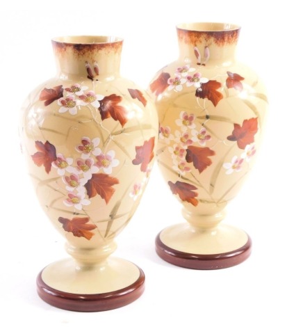 A pair of Victorian milk glass vases, with brown mottled border and foot, with leaves and cherry blossom, 29cm high.