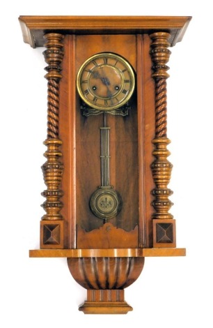 A 19thC walnut cased drop dial wall clock, with barley twist column supports, and a moulded Roman numeric dial, black hands with pendulum, 72cm high, 42cm wide, 19cm deep.