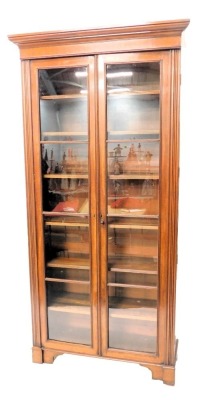 A 19thC mahogany museum cabinet, with a moulded cornice above two astragal glazed doors, enclosing adjustable shelves each, flanked by moulded pilasters, on stepped bracket feet, Chubb brass locking mechanism, 217cm high, 107cm wide.