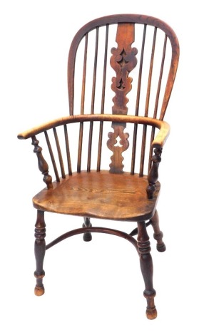 A 19thC ash and elm Windsor chair, with a pierced splat, solid seat on turned legs with crinoline stretcher, old repairs.