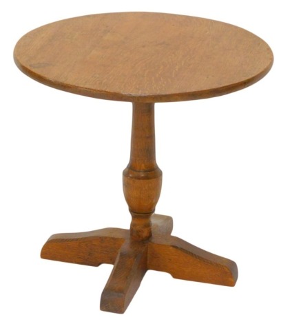 An oak wine or coffee table, in Arts & Crafts style, the circular top turned column and egg shaped base, 48cm high, 51cm diameter.