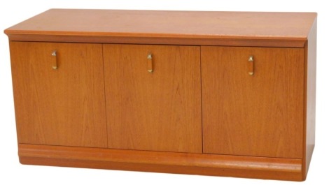 A teak three door low cabinet, with metal handles, 112cm wide.