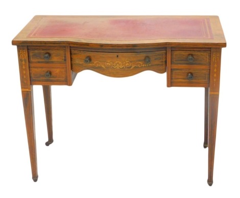 A late 19th/early 20thC rosewood and marquetry writing table, the bowfront top with a red and gilt leather inset, above five drawers on square tapering legs, with ceramic castors, 91cm wide.