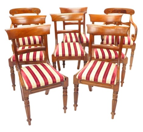 A set of six early Victorian mahogany dining chairs, each with a plain bar back and drop in seat on fluted tapering legs, and two associated open armchairs. (8)