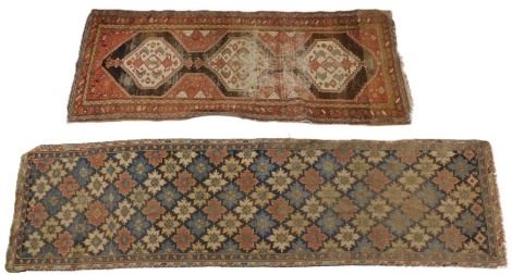 Two early 20thC worn Persian runners, one with a multi coloured geometric design, in blue, red, cream, etc, 326cm x 84cm, the other with a central pole medallion on a red ground, 241cm x 94cm. (2)