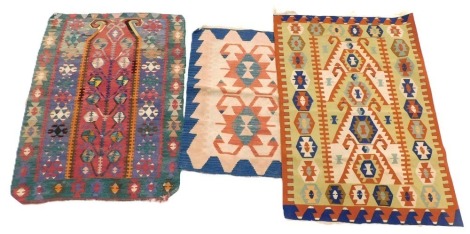 Three Eastern Kilim rugs, each with a multicoloured geometric design, 156cm x 117cm, 138cm x 106cm and 112cm x 84cm. (3)