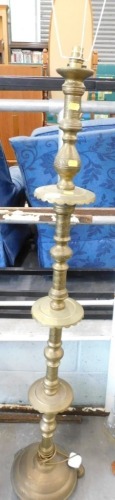 A Middle Eastern brass standard lamp.